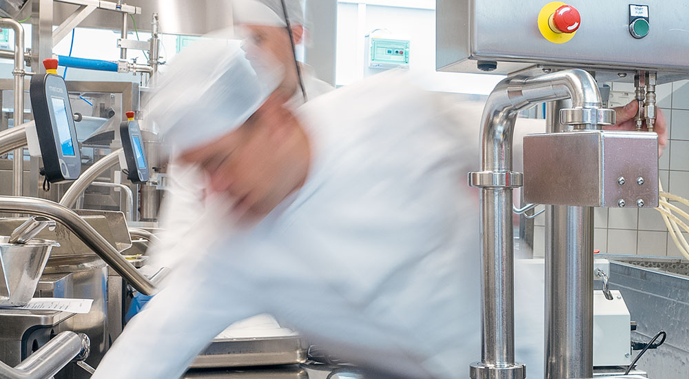 A production kitchen is designed to prepare and portion food in large quantities
